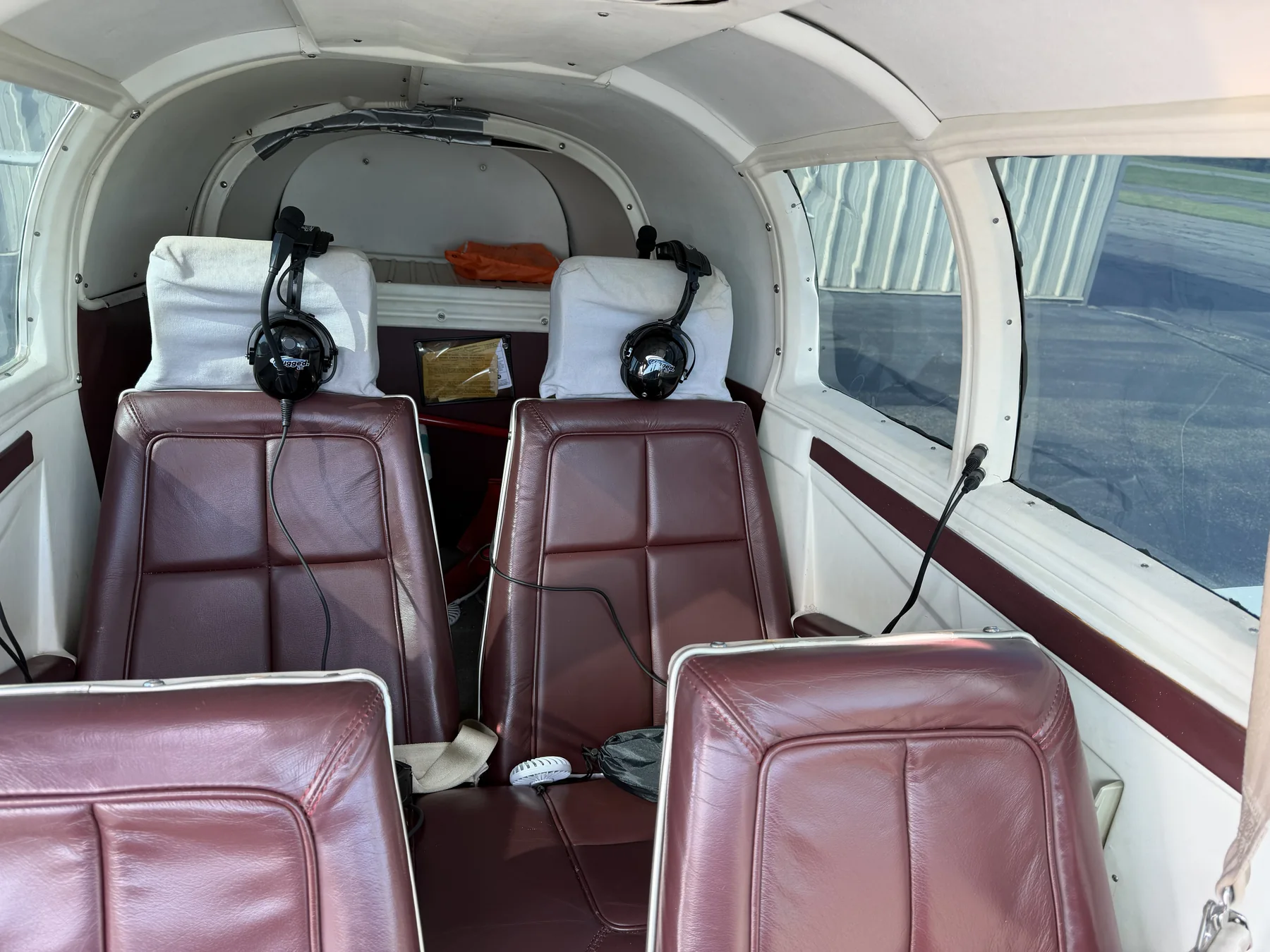 The N9363V cabin interior showing the leather front and rear seats and headsets